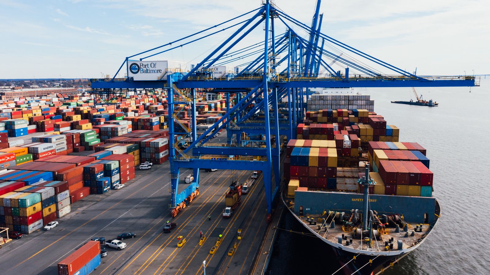 Gantry cranes unloading containers from a cargo ship at a commercial port