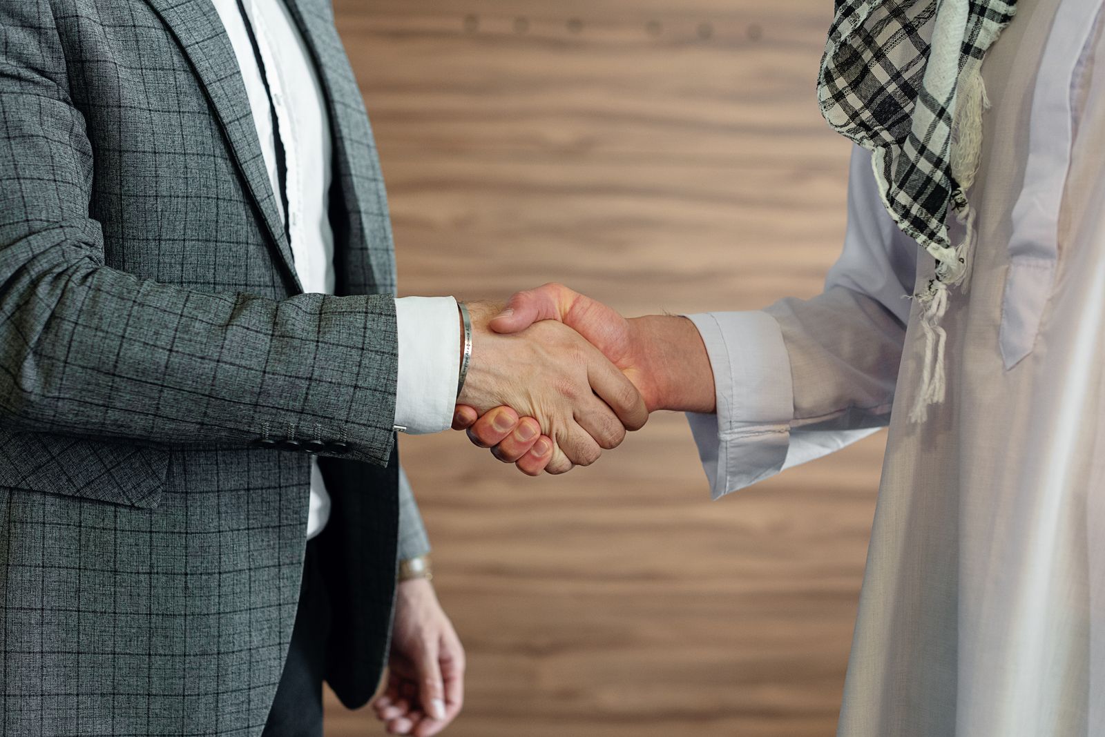 Two business partners shaking hands after agreeing a supply contract
