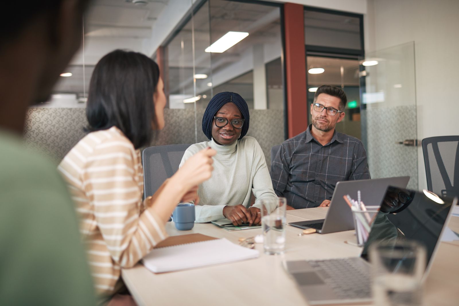 Colleagues reviewing an order together around a meeting-room table