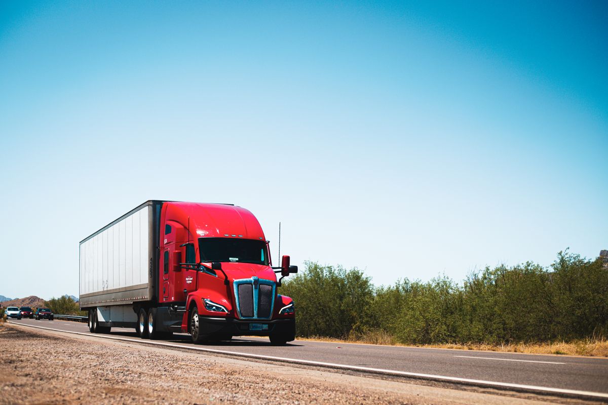 A freight truck hauling a trailer along an open highway