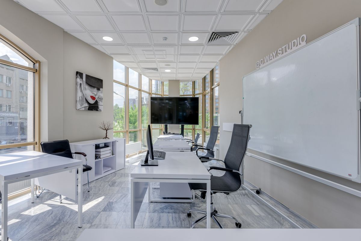 Desks and task chairs arranged in a bright modern office